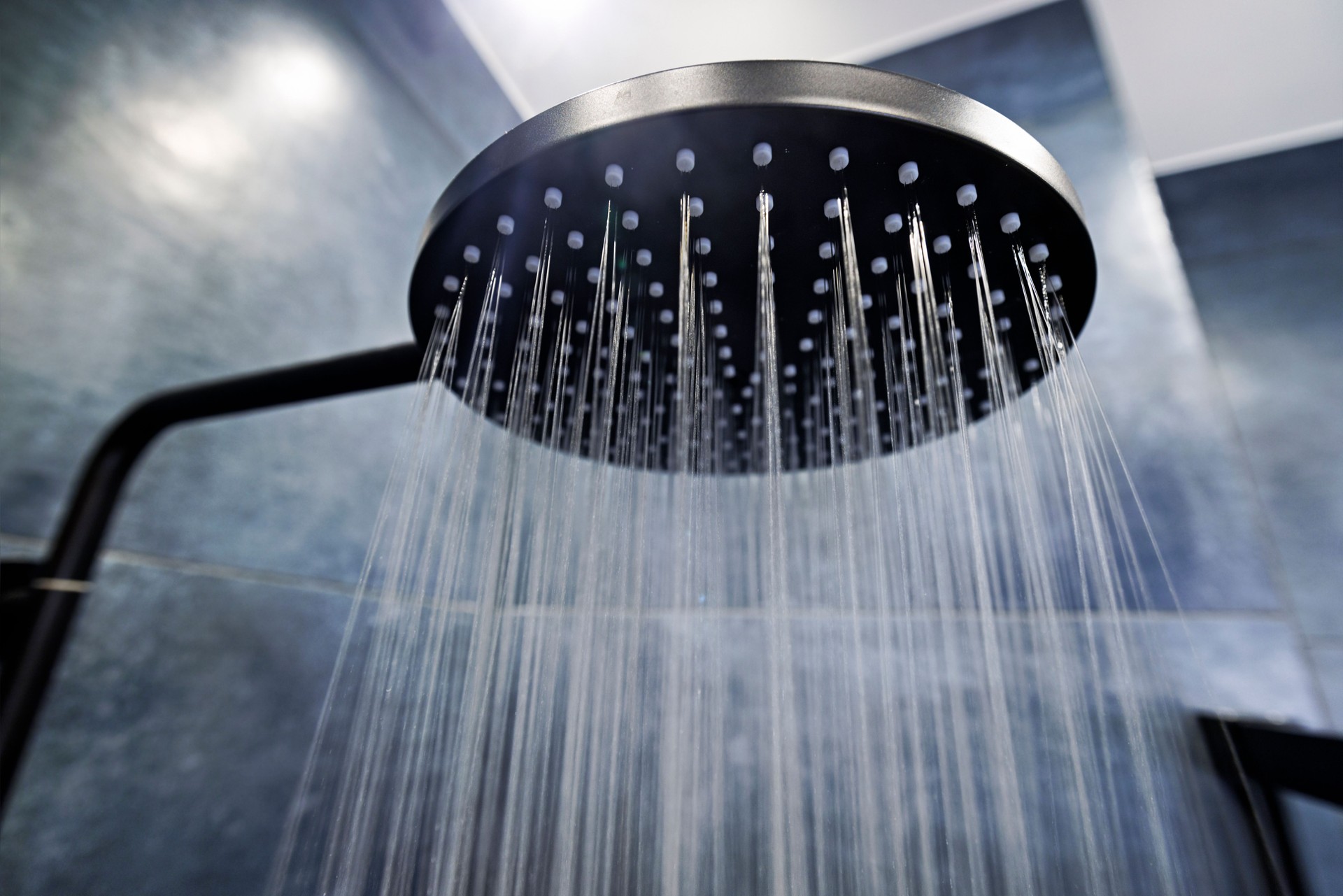 Water running from a black rain shower head