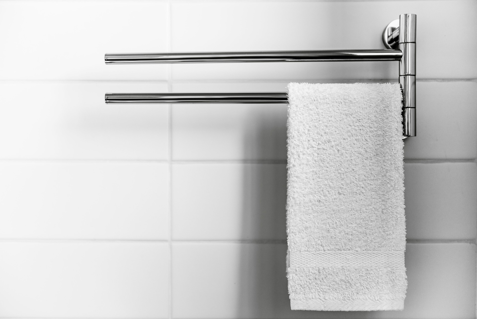 Close-Up Of White Towel Hanging Against Wall At Home